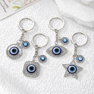 Evil eye keychains set with star and geometric charms featuring crystal rhinestones