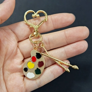 Creative artist palette keychain with paintbrushes and heart-shaped golden clasp gift