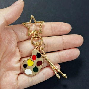 Golden art keychain with palette and brushes pendants featuring star clasp for students