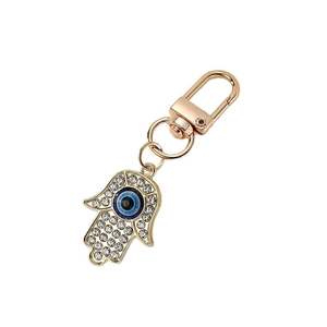 Gouden Hamsa hand-sleutelhanger met blauw boze oog en fonkelende kristallen strass
