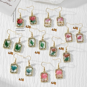 Collection of handmade dried flower resin earrings with gold vintage frames and dimensions