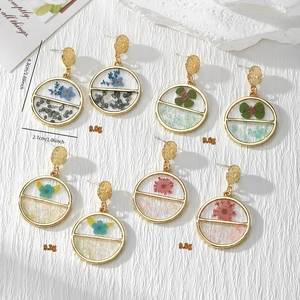 Detail view showing varied colors of handmade resin earrings with real dried flowers