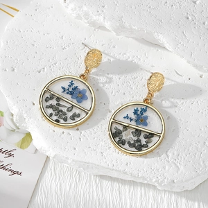 Handmade gold circular earrings with real blue dried flowers and grey resin crushed stones