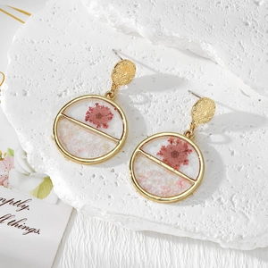 Handmade gold geometric earrings featuring real pink dried flowers and crushed stones