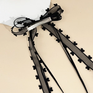 Elegant black mesh bow hair clip with heart flocked edges and long ribbon streamers