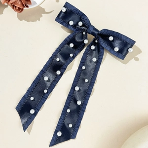 Elegant navy blue satin bow hair clip with white pearls and long ribbon tails