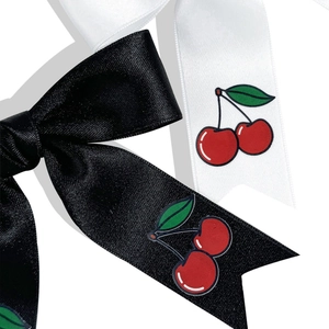 Vue détaillée des barrettes en satin noir et blanc avec motifs de cerises rouges