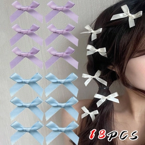 Detailed set of 18 satin ballet-style bow hair clips in purple, blue, and white colors