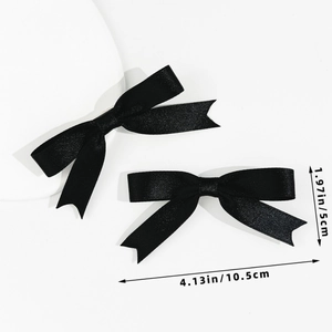 Detail view of black ribbon bow hair clips with specific dimensions of 10.5cm by 5cm