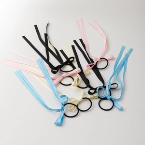 Set of four satin ribbon bow hair ties in black, pink, cream, and blue with long streamers