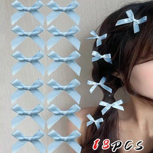 Set of 18 light blue satin ribbon bow hair clips shown on a model for balletcore style