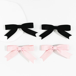 Set of four satin bow hair clips in black and pink colors for elegant side hair styling