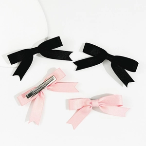 Detail view of the silver metal alligator clip back on pink and black satin bow hairpins