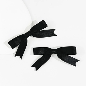 Set of two elegant black satin ribbon bow hair clips for women in minimalist ballet style