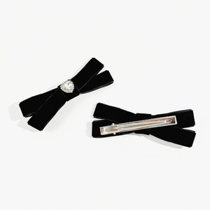 Detail of black velvet bow hair clips with heart crystal and metal alligator clip