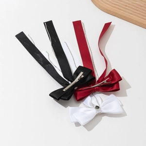 Three bow hair clips in black, red and white with satin ribbons and metal chain tassels