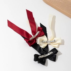 Elegant satin bow hair clips set in red, cream, and black with silver metal spring clips