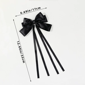 Detail view of large black satin bow hair clip with long ribbons and size dimensions