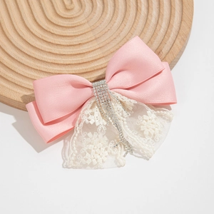 Pink satin bow hair clip with rhinestone tassels and white floral embroidery lace detail