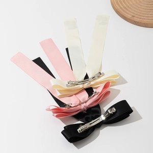 Elegant satin bow hair clips in cream, pink, and black colors with long tassels