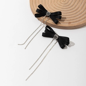 Detail of black satin bow hair clips with heart rhinestone and long crystal tassels