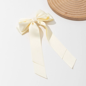 Elegant cream satin bow hair clip with long ribbons and premium polished finish