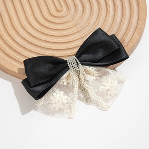 Elegant black satin and white lace bow hair clip with sparkling rhinestone tassels