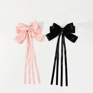 Elegant long ribbon bow hair clips in pink and black satin for a sweet vintage style