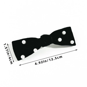 Detail showing the 12.5cm size of a black velvet hair clip with white pearl beads