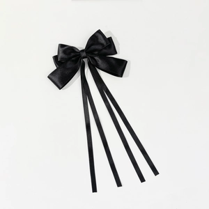 Elegant long black satin bow hair clip with flowing ribbons for women's hair styling