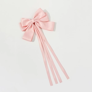 Elegant long pink satin bow hair clip with flowing silk ribbons on a white background
