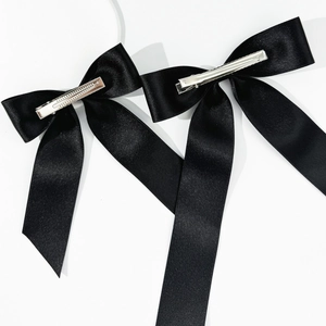 Elegant pair of black satin bow hair clips with silver metal duckbill clips for women