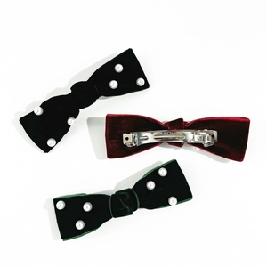 Three-piece velvet bow hair clips with hand-sewn pearls in black, red, and green colors