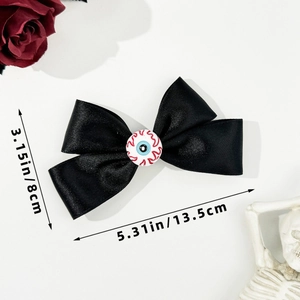 Detailed view of Gothic Halloween bow hair clip with eyeball design and dimensions