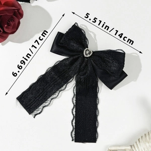 Close-up of black lace bow hair clip with silver heart rhinestone and size measurements