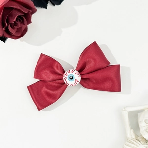 Gothic wine red ribbon bow hair clip with realistic eyeball detail for Halloween