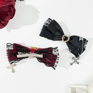 Gothic bow hair clips with black lace, heart gemstone, and silver cross pendants detail
