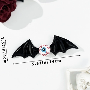 Detailed view of Halloween bat wing hair clip with eyeball showing dimensions 14x4cm