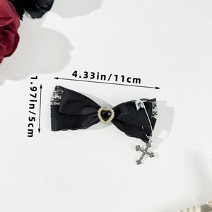 Detail of gothic lace bow hair clip with black heart gem and silver cross charm