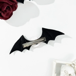 Detailed view of black bat wing hair clip with gothic embroidery for Halloween accessory