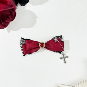 Gothic wine red bow hair clip with black lace and silver cross pendant on white background