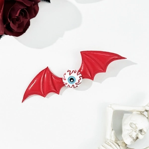 Halloween bat wing hair clip with bloodshot blue eyeball design on white background