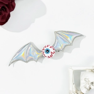 Spooky Halloween hair clip with eyeball and silver laser bat wings on white background
