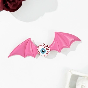 Macro shot of Halloween bat wing hair clip with a detailed bloodshot eyeball element