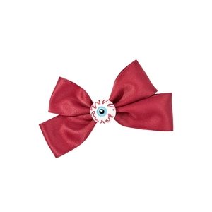 Gothic Halloween hair clip featuring a red satin bow with a detailed blue eyeball center