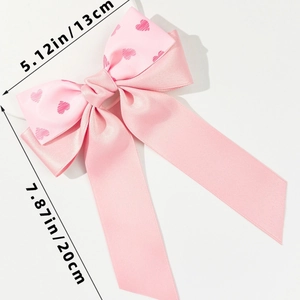 Barrette nœud rose avec motif cœur, dimensions 13 cm de large et 20 cm de long