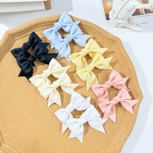 Sweet ribbon bow hair clip set in six colors on a cork tray for girls' hairstyles