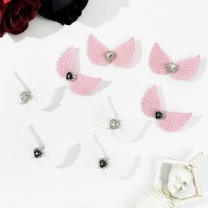 Gothic angel wing hair clips with rhinestone hearts on dark aesthetic background