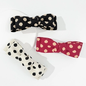 Three elegant polka dot bow hair clips in black, burgundy and off-white colors