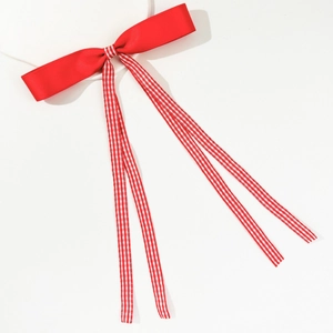 Red satin bow hair clip with long plaid ribbons in sweet preppy style on white background